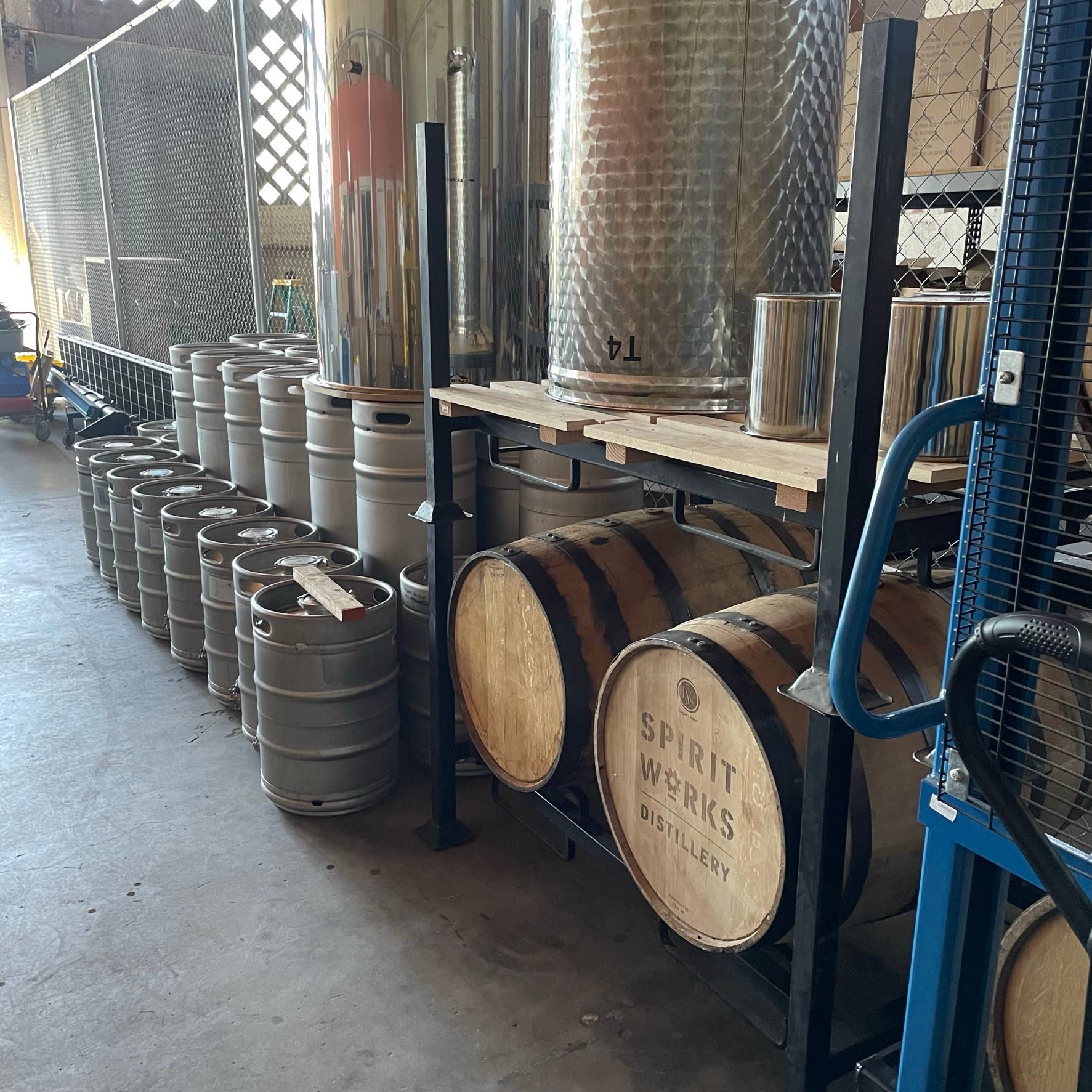 A room full of barrels and kegs at Spirit Works distillery. 