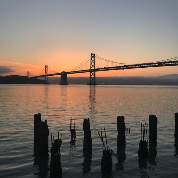 The Bay Bridge at sunset as seen from an East Bay dock.